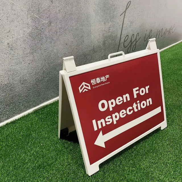 White plastic A-frame sign for real estate.