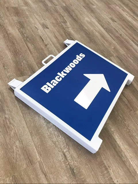 Yellow plastic A-frame sign holder for real estate.