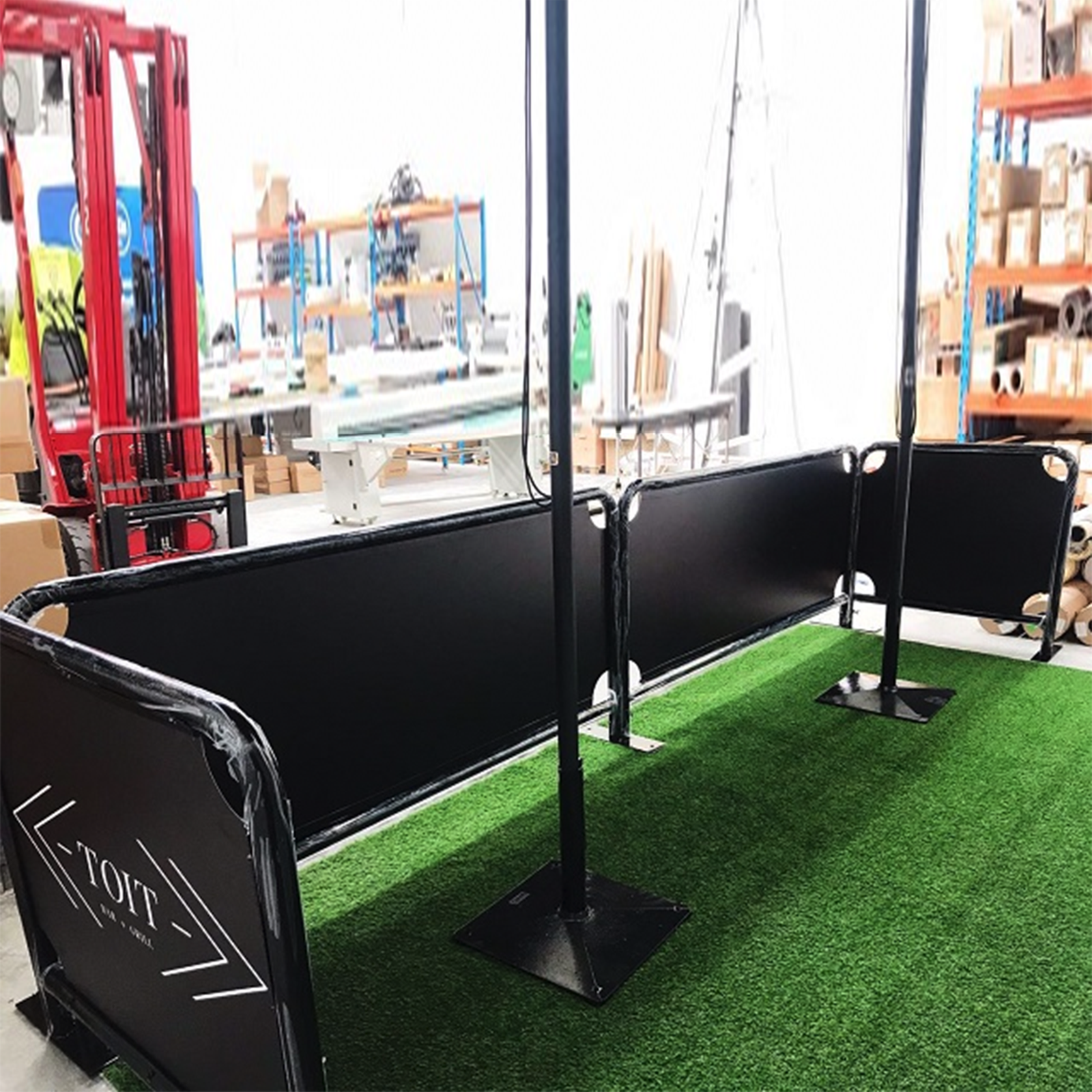 Fabric café barrier with dark metal frame.