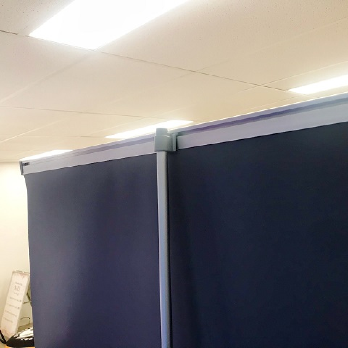 Portable pull-up banner stand, ideal for trade shows and events. Features a retractable design and printed graphic for easy display.