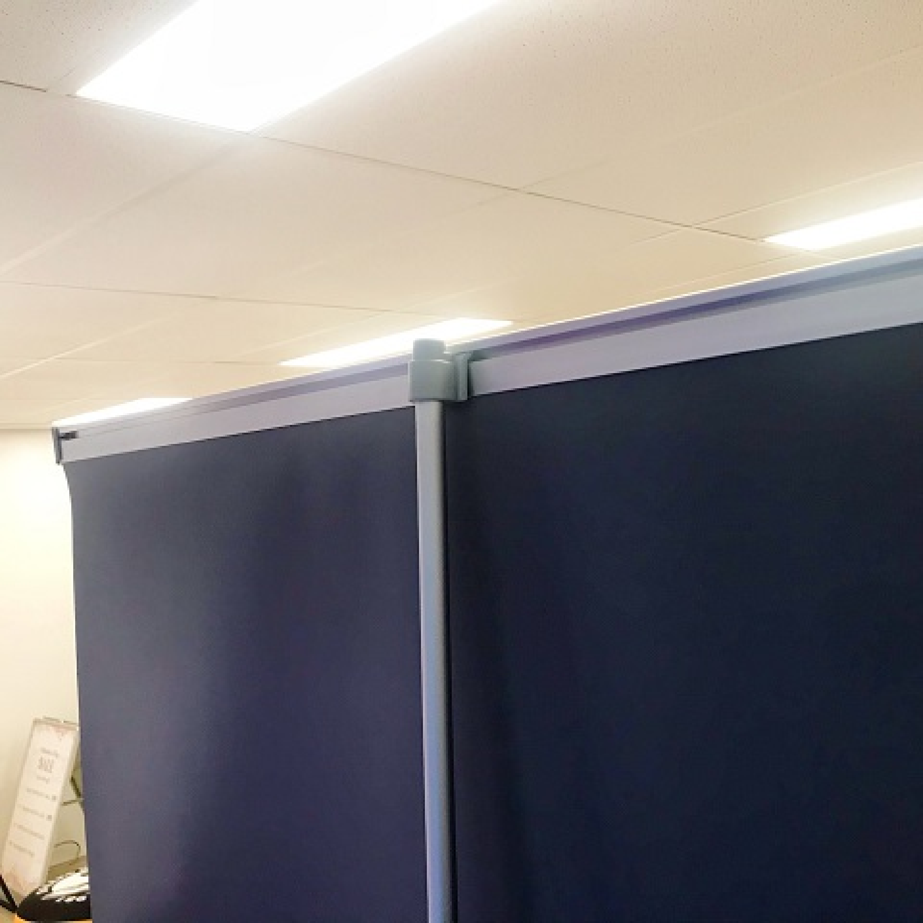 Portable pull-up banner stand, ideal for trade shows and events. Features a retractable design and printed graphic for easy display.