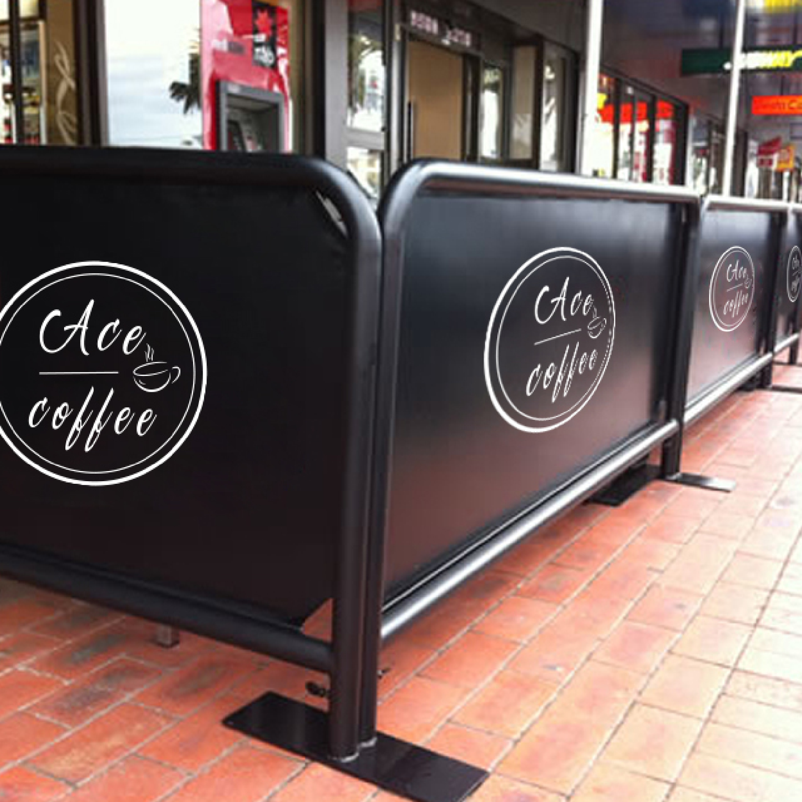Outdoor barriers defining a café's seating area.
